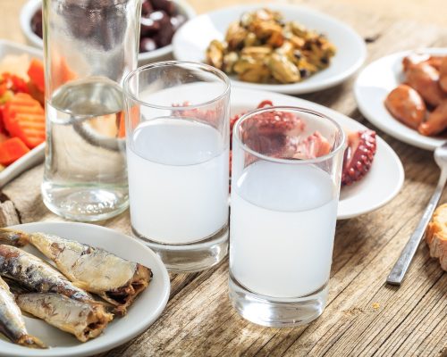 Glasses of ouzo and appetizers